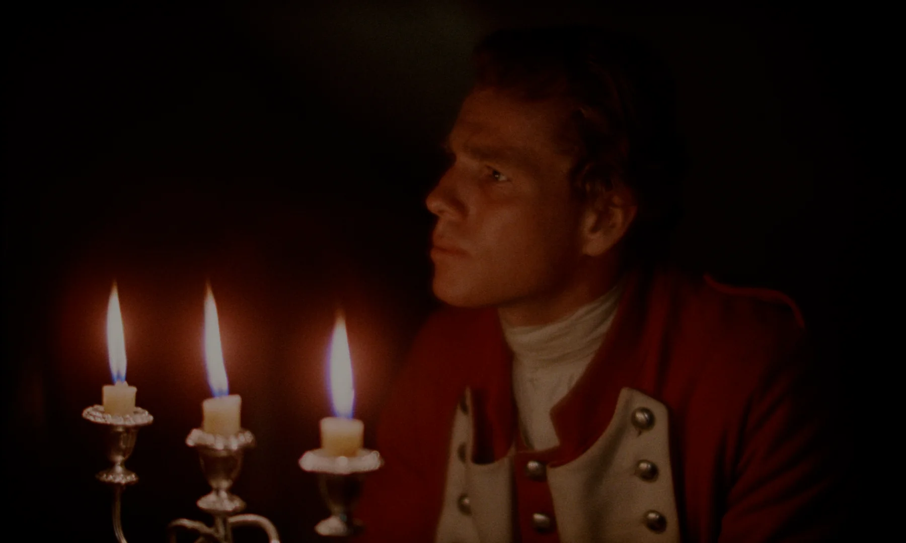 Barry Lyndon (1975) β an officer in a red coat lit only by three candle flames, warm and shallow