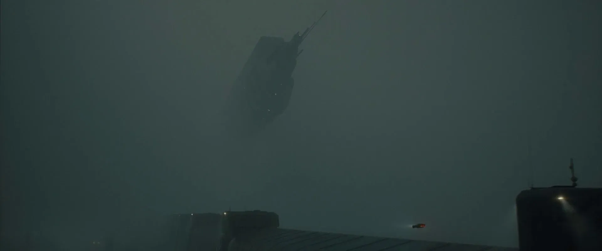 Blade Runner 2049 (2017) β a spinner emerges from thick grey fog above a misty seawall