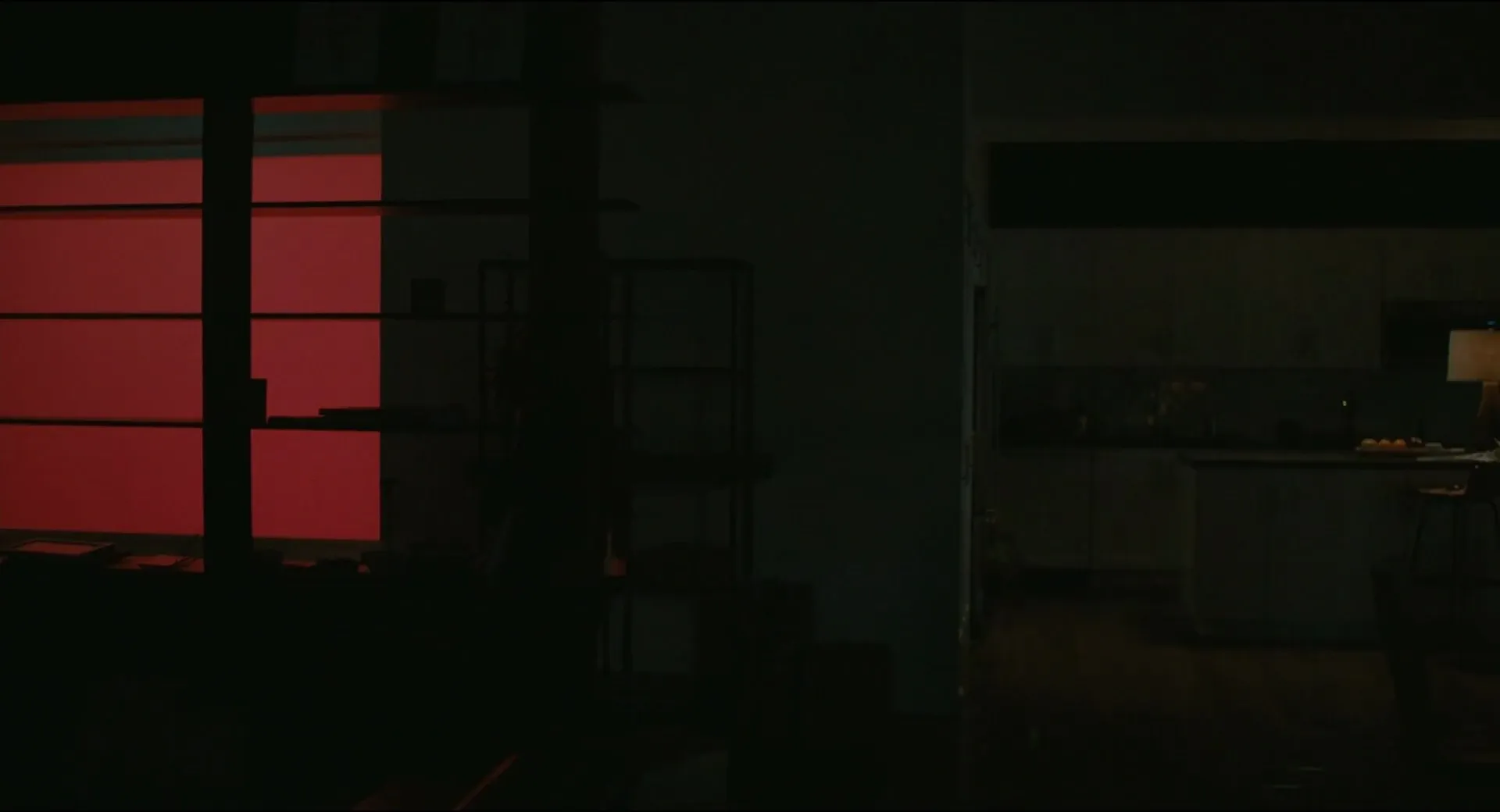 Her (2013) — a warm red window panel glows through a darkened apartment