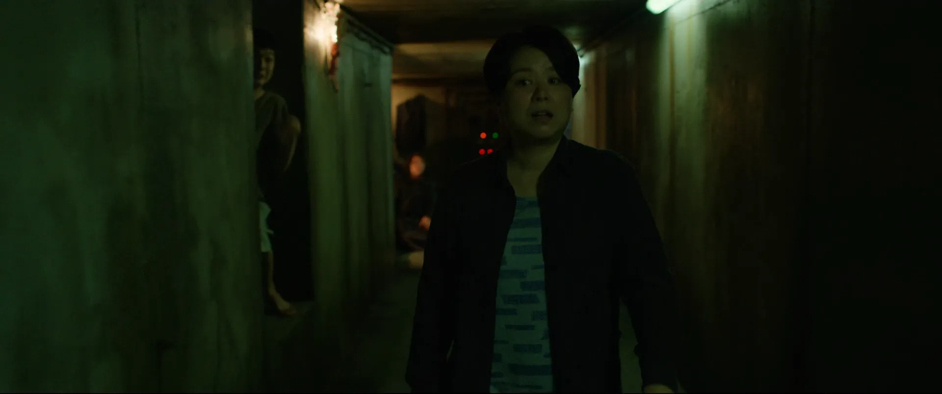 Parasite (2019) — the hidden bunker beneath the Park house, lit in green