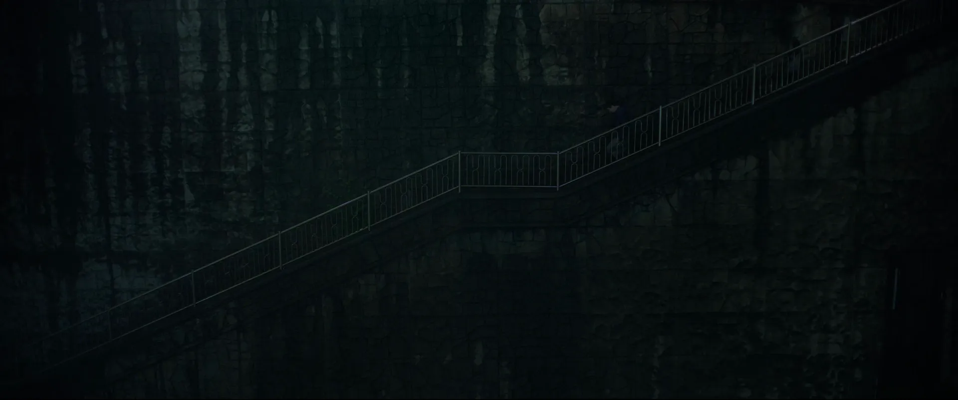 Parasite (2019) — a stone stairway climbing a dark exterior wall
