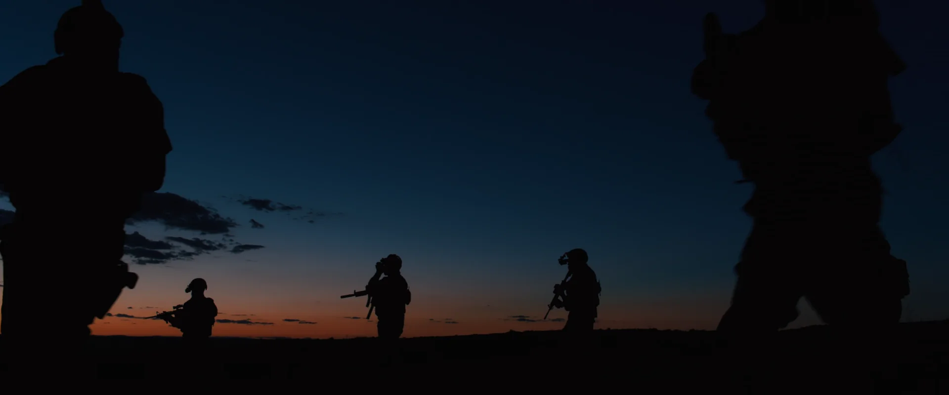 Sicario (2015) — the team silhouetted against the last light of dusk, the moment a schedule either makes its day or loses it to the dark