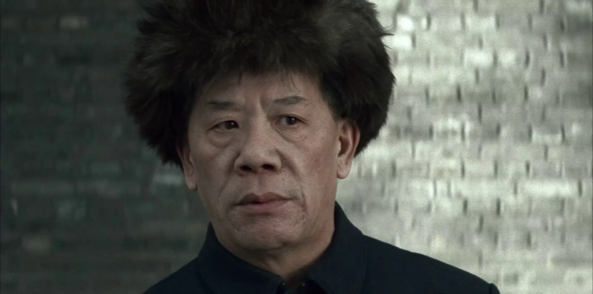 The Last Emperor (1987) — the same man decades later, drained to cold desaturated grey-green: color as the language of a life narrowed by history.