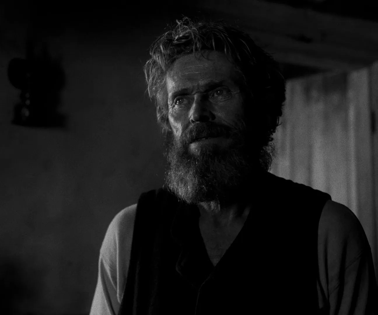 Jarin Blaschke's monochrome cinematography for The Lighthouse (2019): a weathered, bearded man lit by a single hard source against near-black shadow