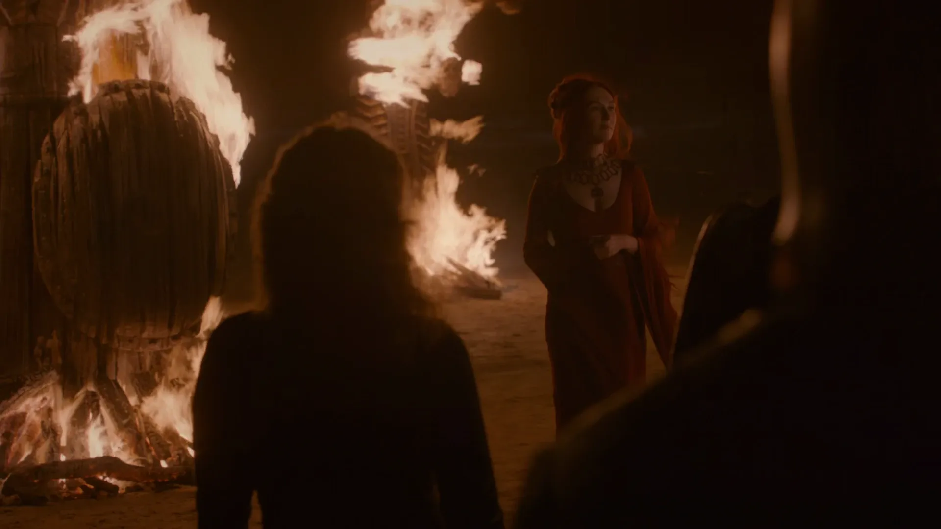 Game of Thrones — a night gathering lit by open fire against the dark